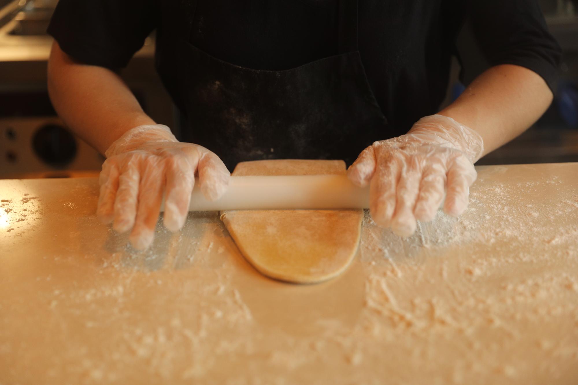 Close-up of hands kneading dough